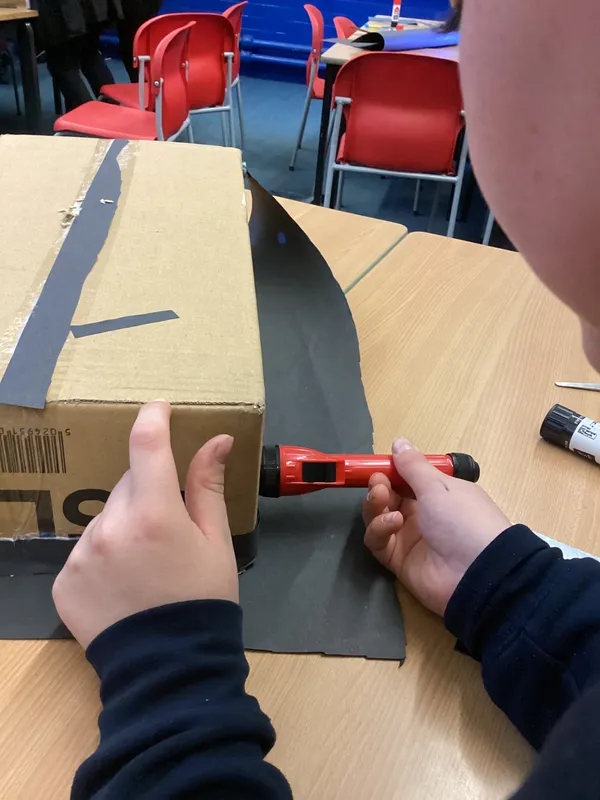 Ospreys were challenged to make a torch light shine into a box and come back out of the same side in a different place using mirrors - image 1 Ospreys were challenged to make a torch light shine into a box and come back out of the same side in a different place using mirrors - image 1