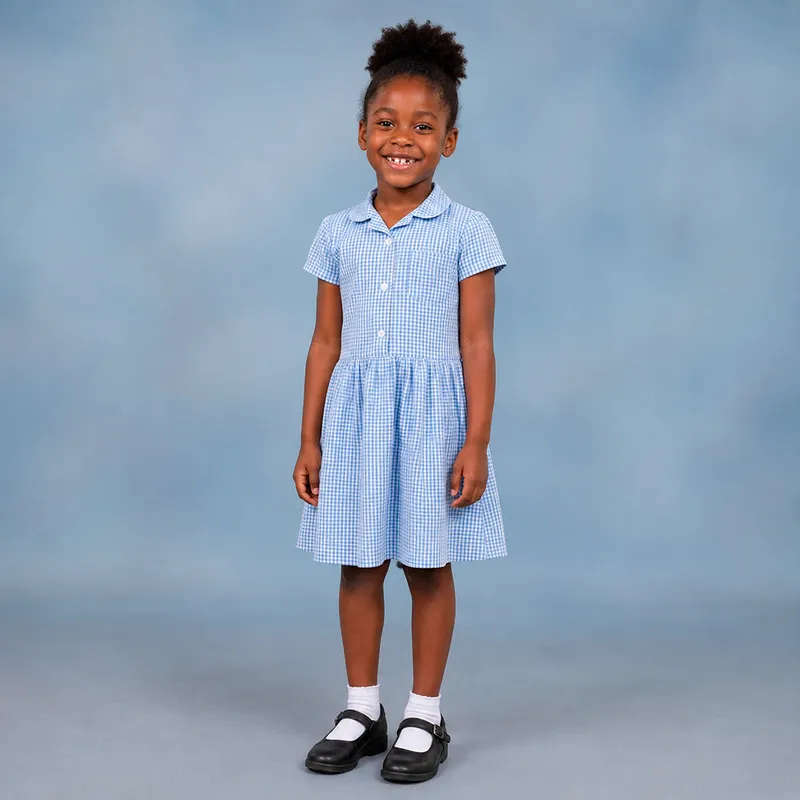 Girl wearing blue checked summer dress.