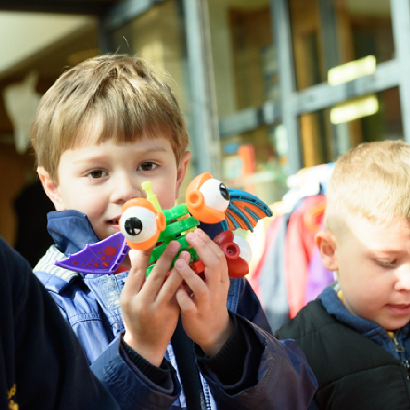 A school student holding a toy