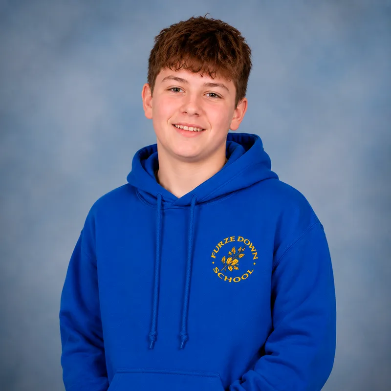 Boy wearing blue hoody with school logo.