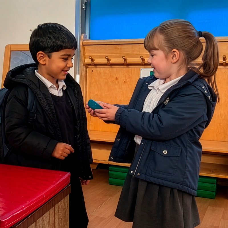 Two pupils chatting together in the school cloakroom.