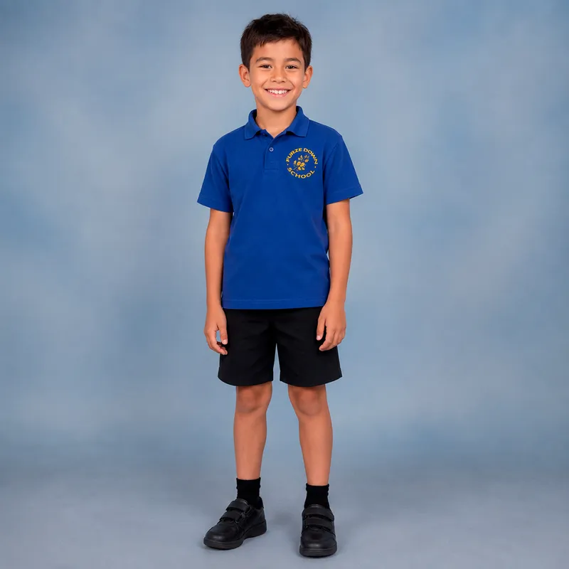 Boy wearing blue polo shirt with school logo and black shorts.