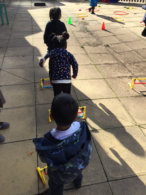 Children jumping over hurdles