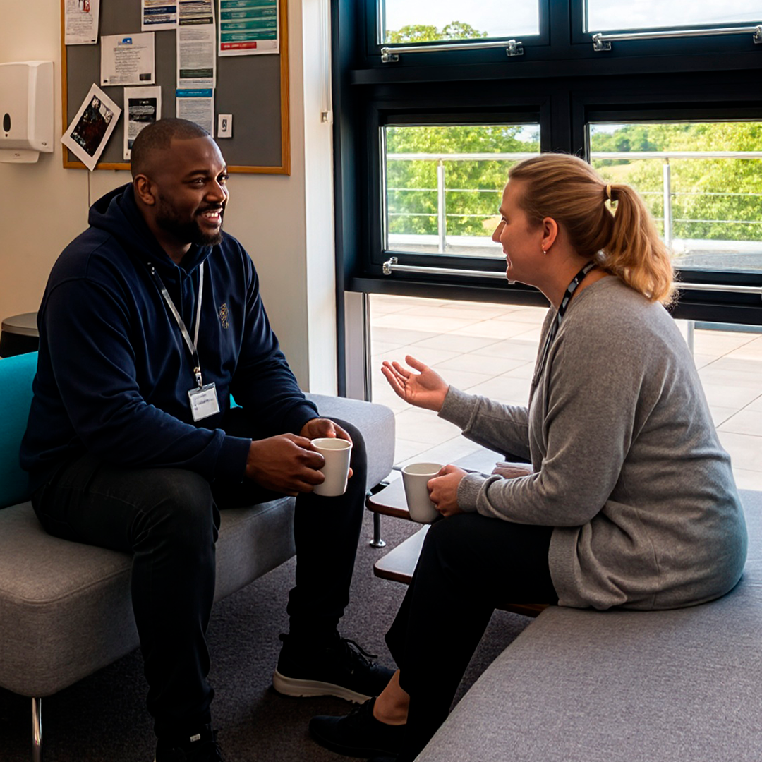Staff members chatting together over refreshments in the staffroom.